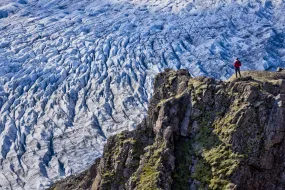 Kieran Baxter standing above a glacier