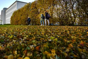 People walking towards University of Iceland Main Building in the fall