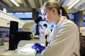Scientist working at a microscope