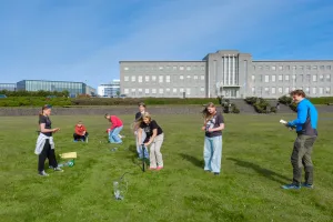 Students in the University of Youth out on the field outside the university's Main Building.