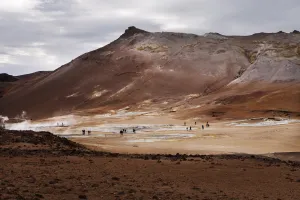 Tourists exploring geysers.